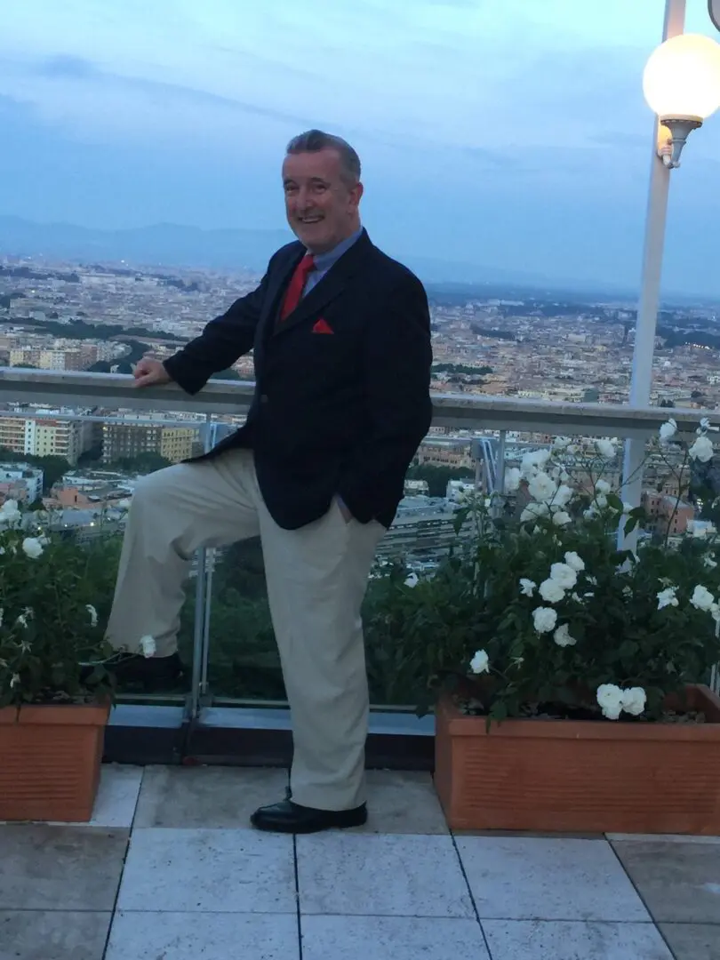 A man standing on the balcony of his hotel room