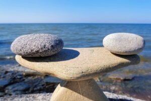 Two rocks on a table near the ocean